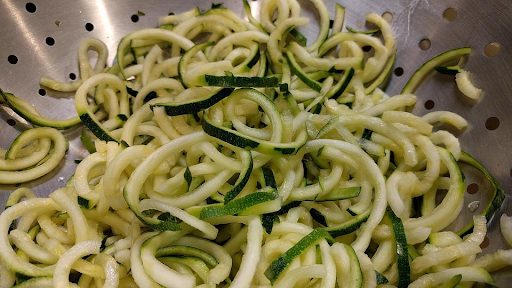zucchini noodles in a colander